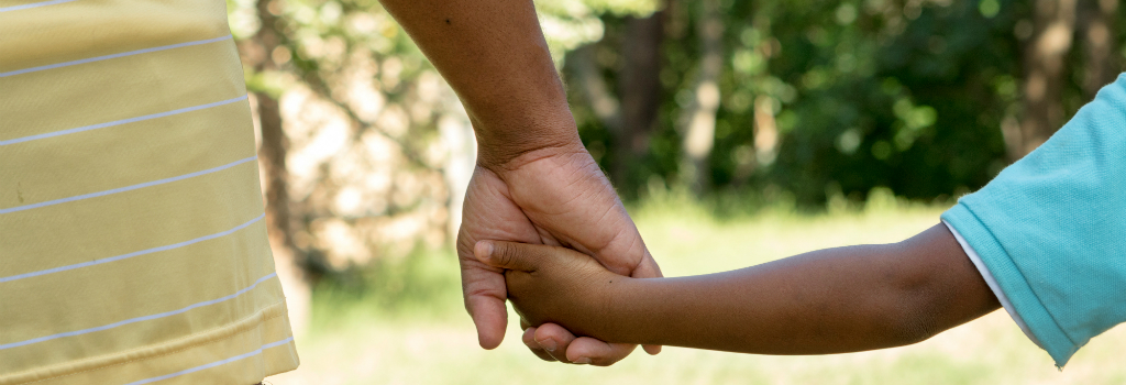 Father and son holding hands representing family green cards for members of lawful permanent residents for Shaftel Law