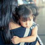 Mother holding child representing crime victims and VAWA for Denver immigration firm Shaftel Law