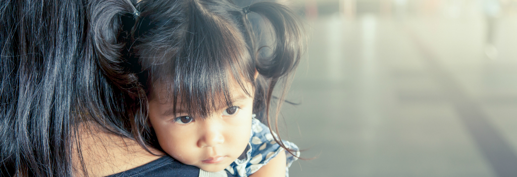 Mother holding child representing crime victims and VAWA for Denver immigration firm Shaftel Law